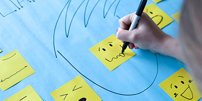 Start drawing faces that reflect different emotions on the Post-it® Super Sticky Notes