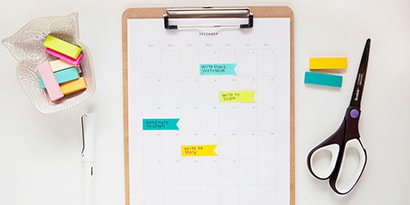 Write reminders on Post-it® Page Markers, stick them on the calendar